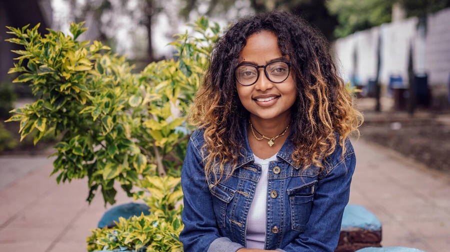 Mielena, a young woman, smiles at the camera