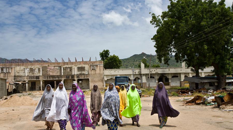 Women walk along a street in Gwoza, Nigeria.