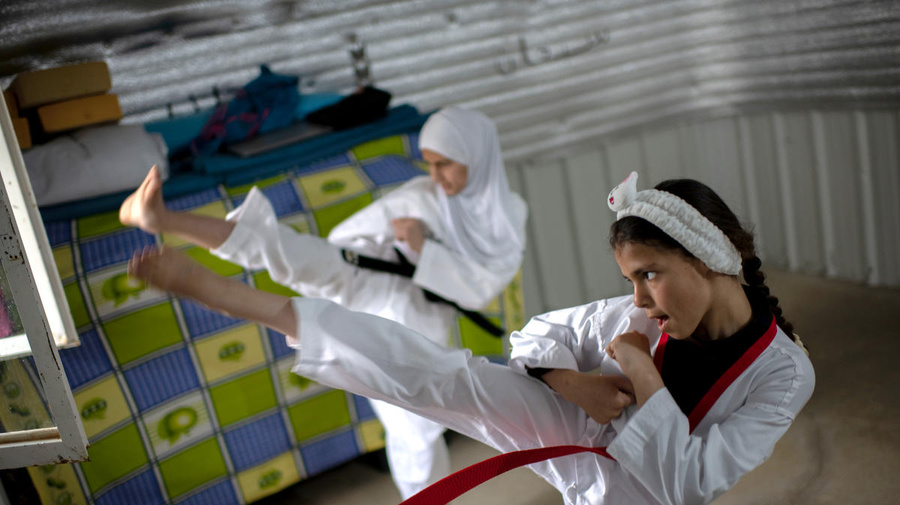 Syrian sisters practice Taekwondo at their home in Azraq refugee camp, Jordan, during lockdown.
