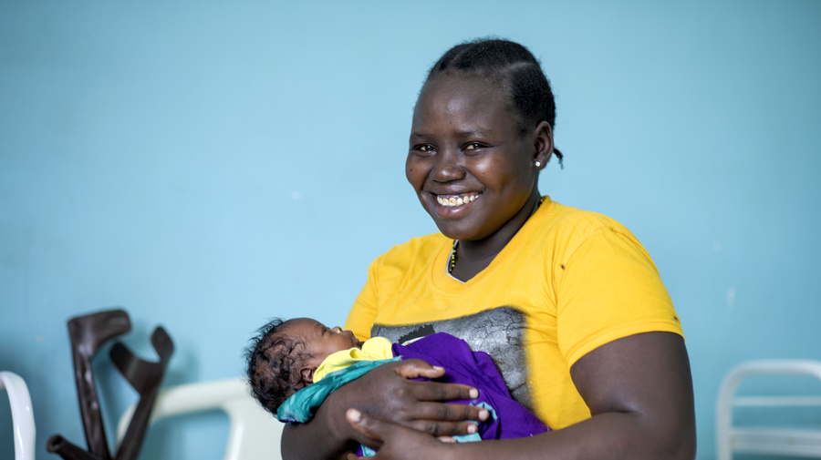 UNHCR UN Refugee Agency - South Sudanese refugee Lucia Amoo, 23, holds her baby boy, Kevin, who was born at Nalemsokon health clinic in Kakuma camp, Kenya, during the pandemic.