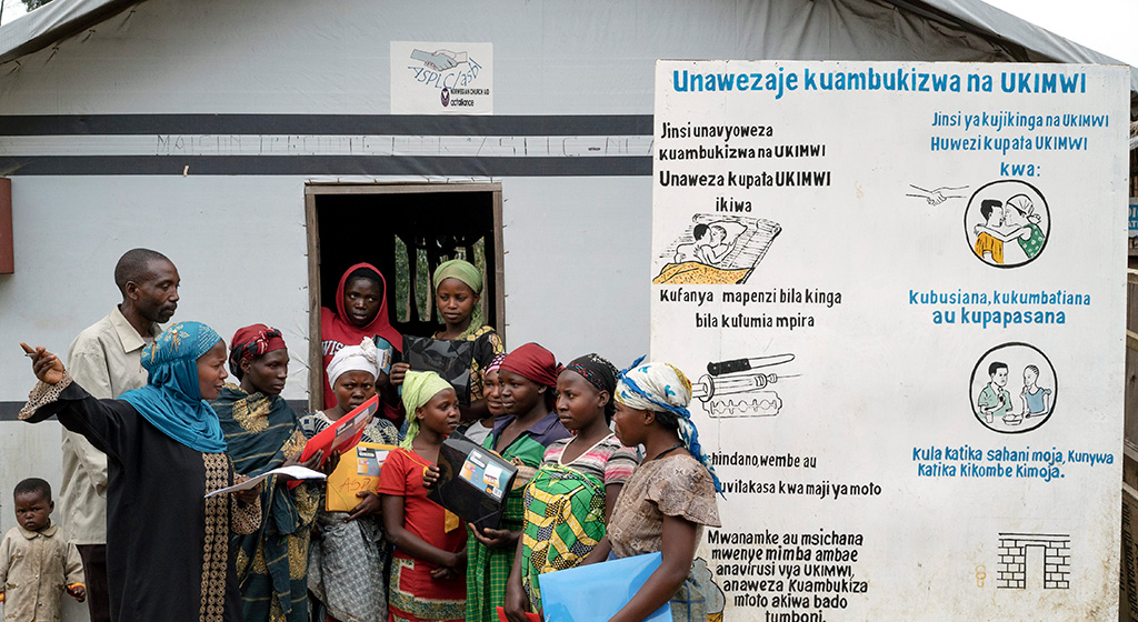 Congolese women at a camp for the internally displaced discuss the dangers of HIV/AIDS in 2014. Agencies such as UNHCR were active in projects to try to reduce the spread of sexually transmitted disease among an estimated 2.6 million IDPs in the Democratic Republic of Congo.