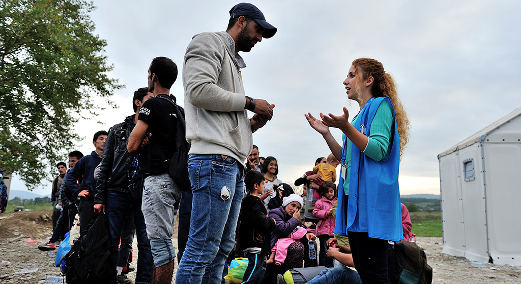 UNHCR translator providing face-to-face information at the Vinojug Reception Centre just inside the Macedonian border from Greece. 