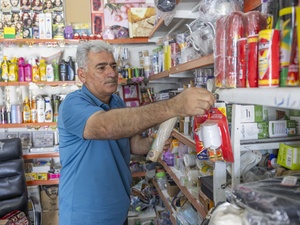 Hawas arranges stuff at his shop in Gawilan refugee camp.