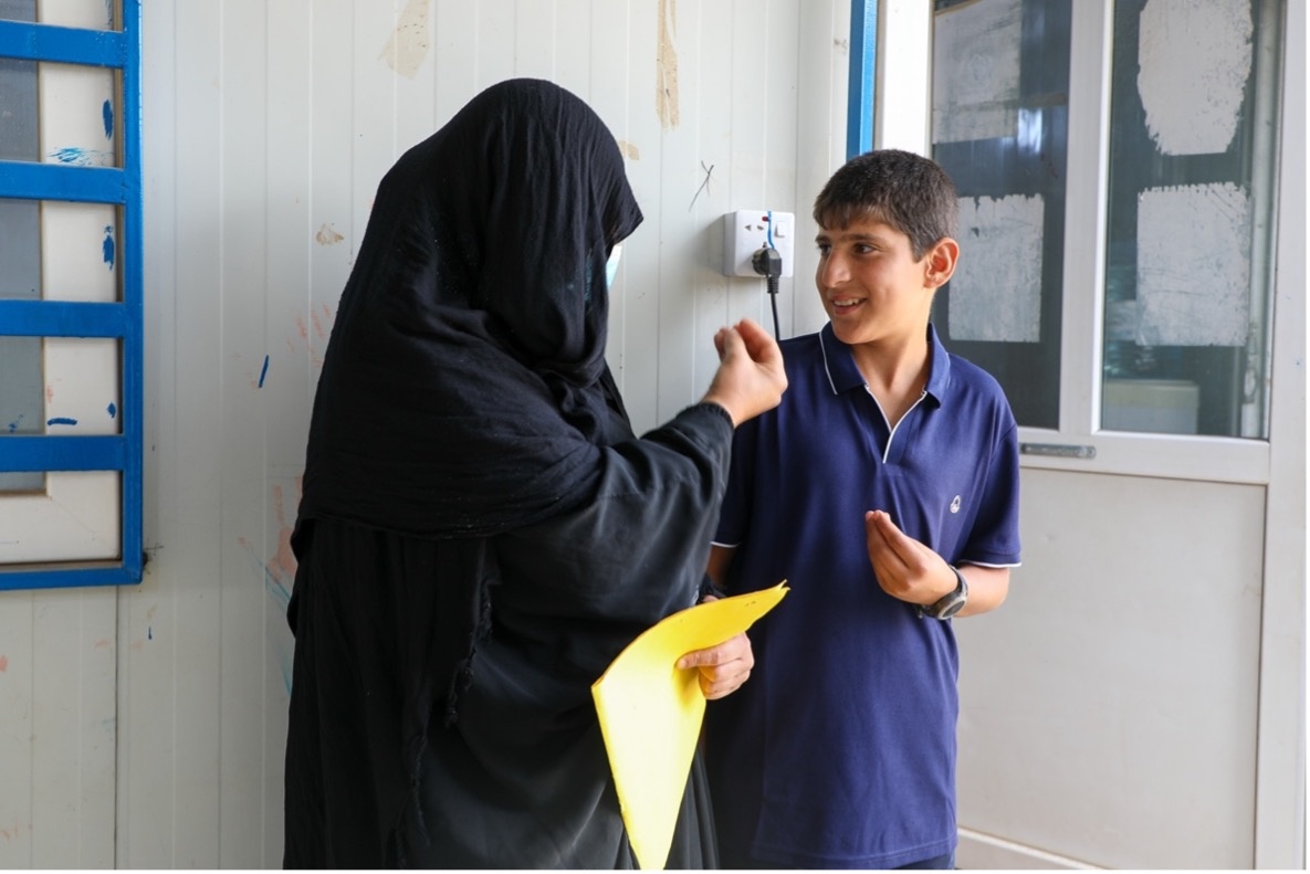 Hind and her son Abdulrahman speak in sign language. &copy; UNHCR/Lilly Carlisle