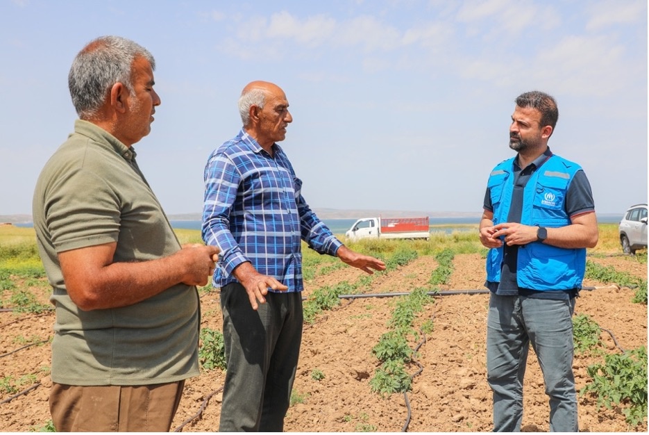Sulayman and his brother, Abdulqdir, speak with UNHCR field staff about how their family uses the rented land to grow produce and earn a living. &copy; UNHCR/Viola Eleonora Bruttomesso