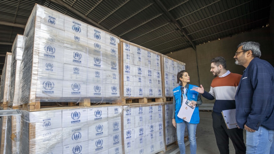 UNHCR team inspect delivered items at the warehouse.