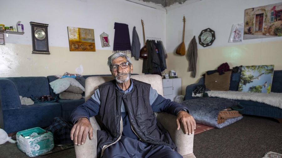 Jasim Shareef sits in a small room inside an unfinished school building where he and other vulnerable refugee families live.