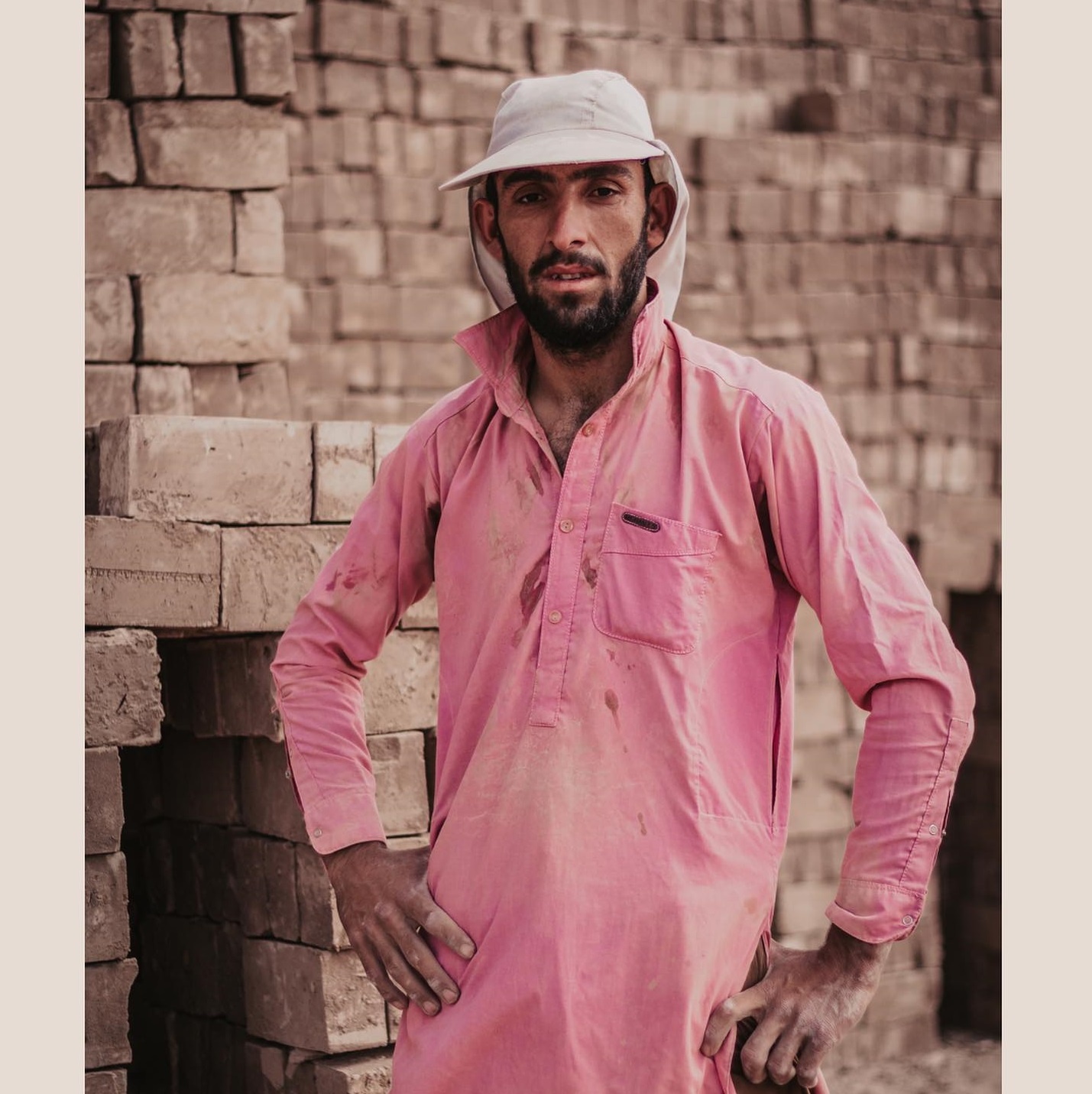 Man in pink shirt  helping in construction