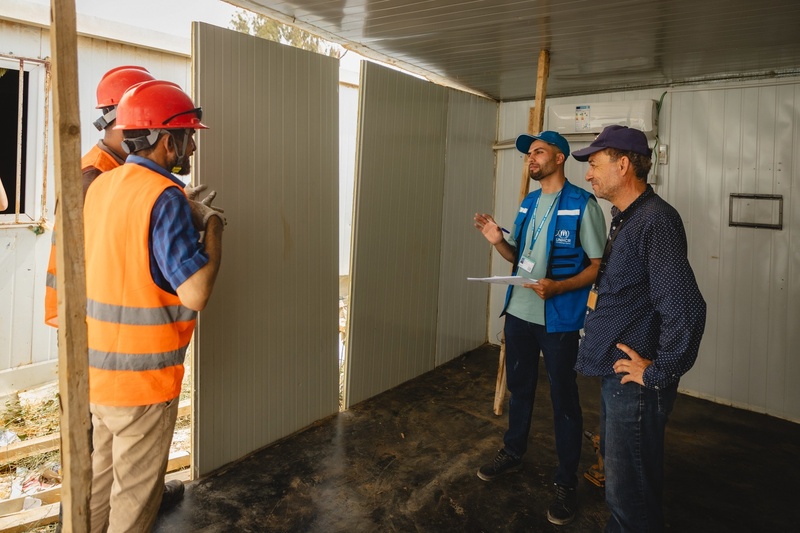 Mohammad talking with other workers in the site in Zaatari Camp