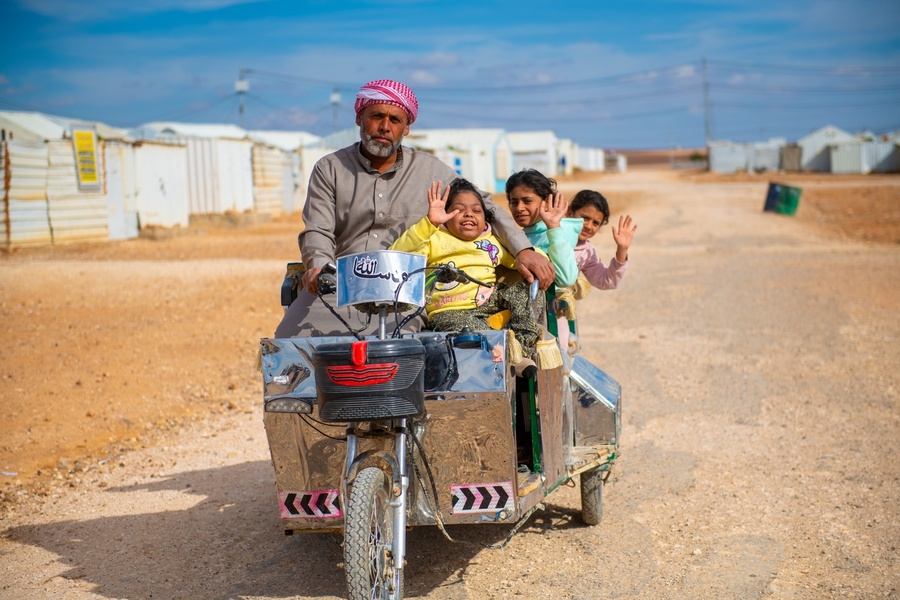 Abu Zainab, taking out his children for a ride, using his electrical bike