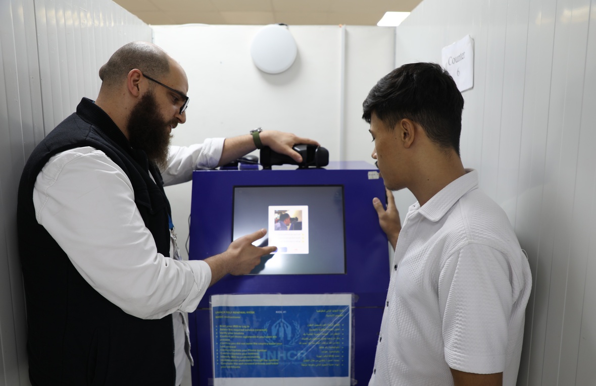 Syrian refugee renewing his ASC through the kiosk
