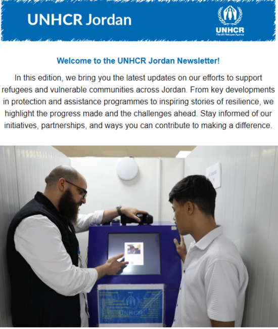 UNHCR staff showing a refugee how to use the Kiosk
