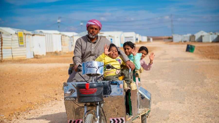 Abu Zainab, taking out his children for a ride, using his electrical bike