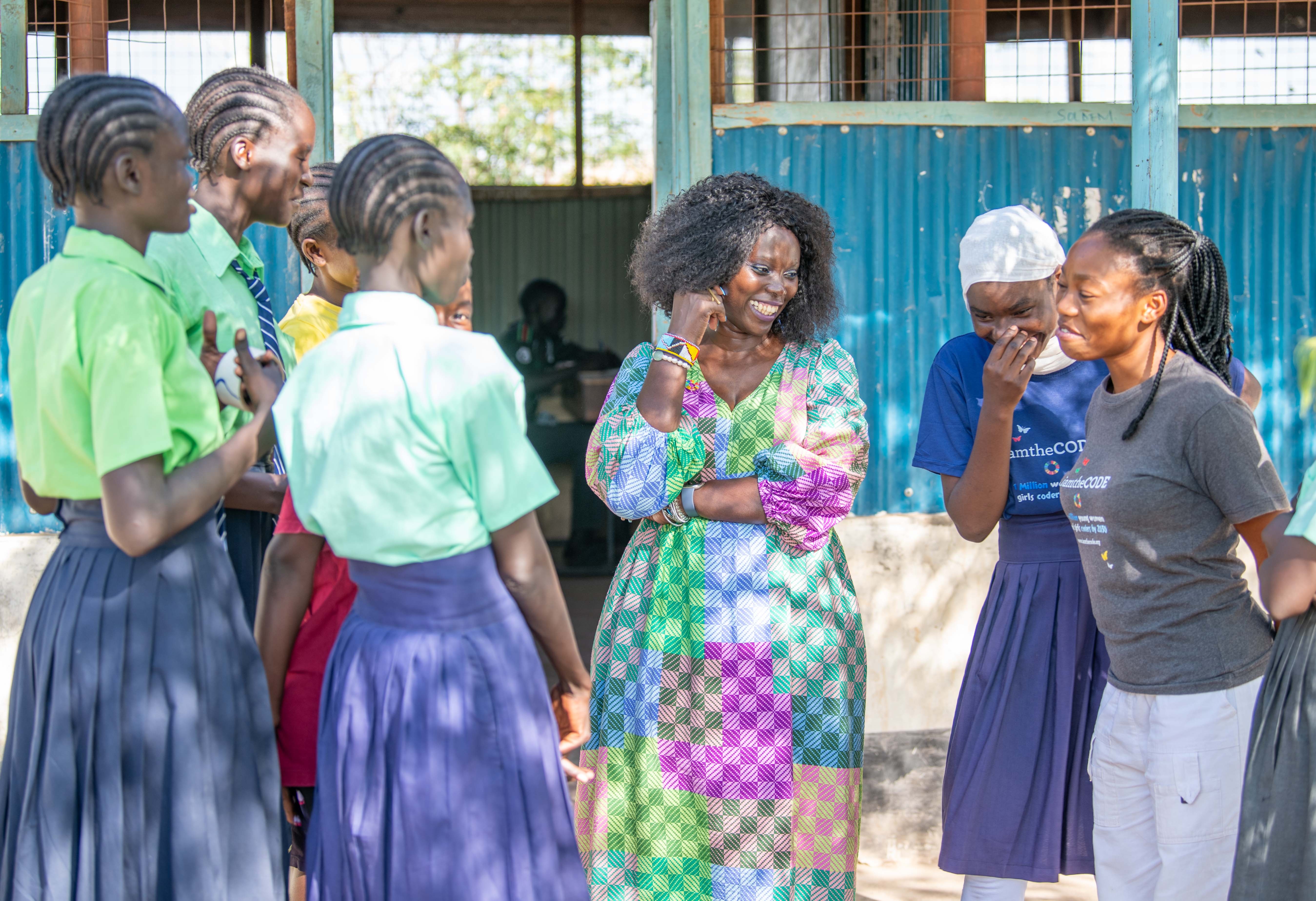 Lady Marieme poses with girls attending a mentorship session in Kakuma.