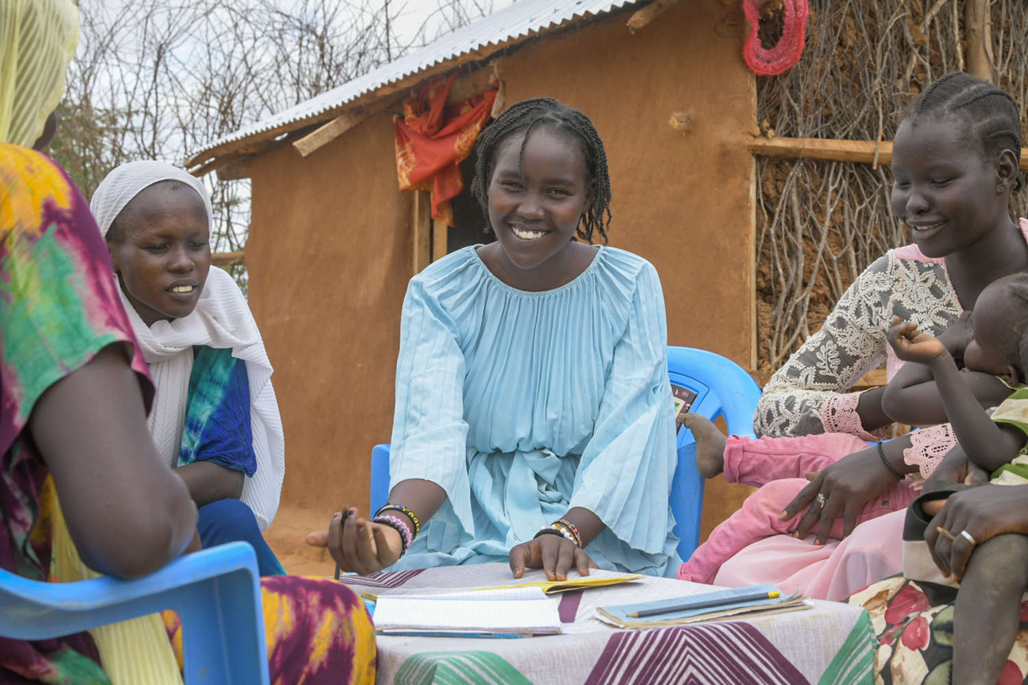 Faith poses for a photo in Dadaab with refugee women and girls that she teaches