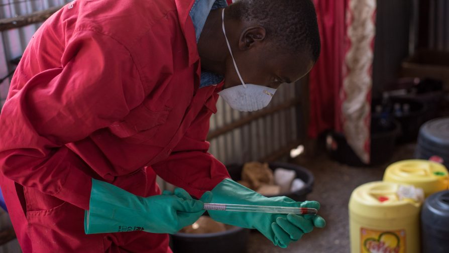 Innocent meticulously checks for the PH level as one of the processes in making liquid soap ©UNHCR/Samuel Otieno