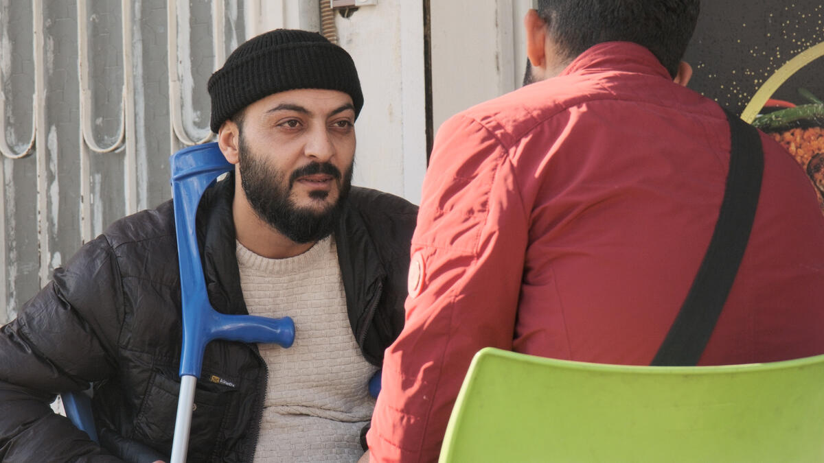 Turkiye. Syrian earthquake survivor Abdullah Al-Khatib speaking with another survivor.