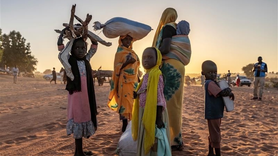 A group of people standing in the sand