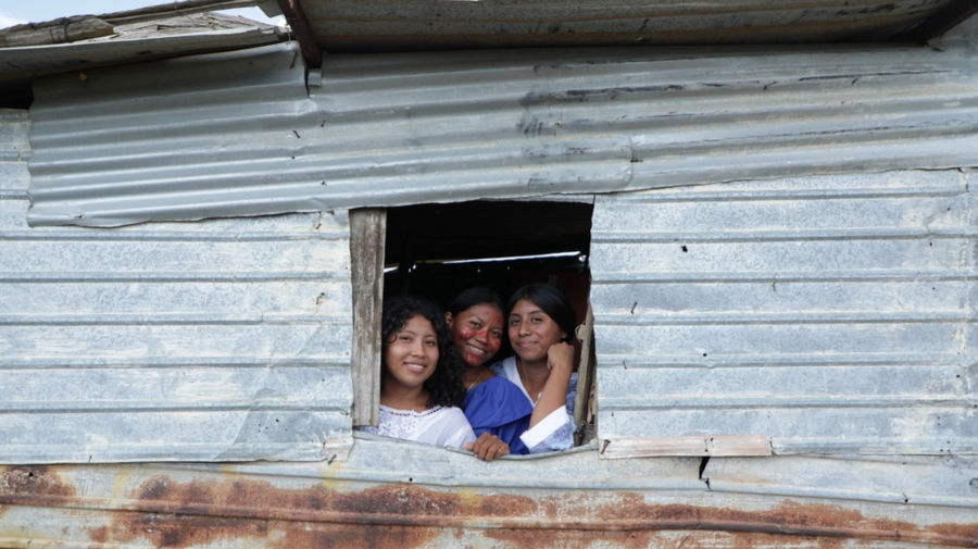 Maria Palacio, a Venezuelan Wayuu teacher and leader, with her family in her house made of zinc sheets.