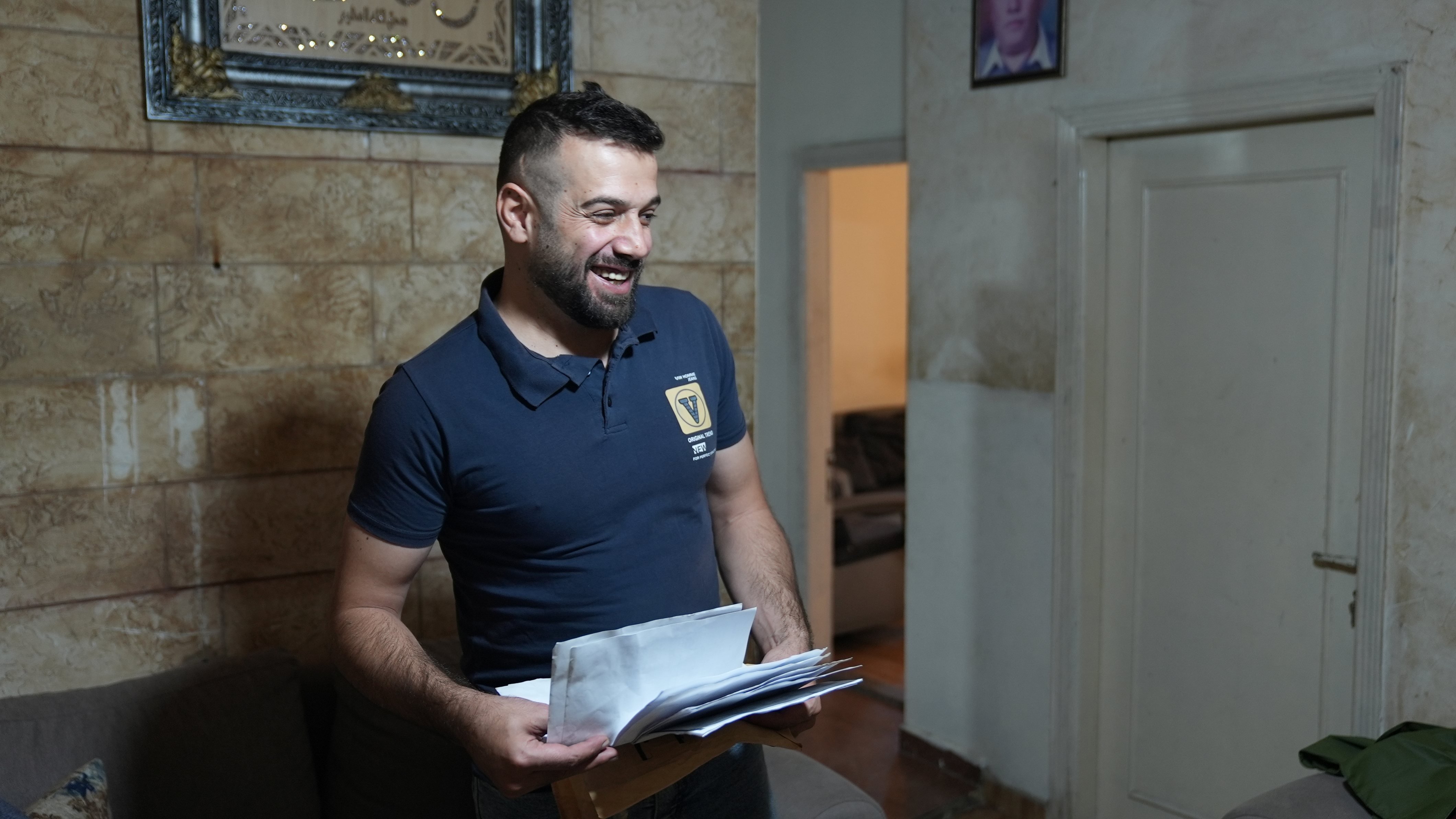 Holding the documents related to his case, Hussain reflects on the legal process that led to the recognition of his nationality, supported through legal aid. 