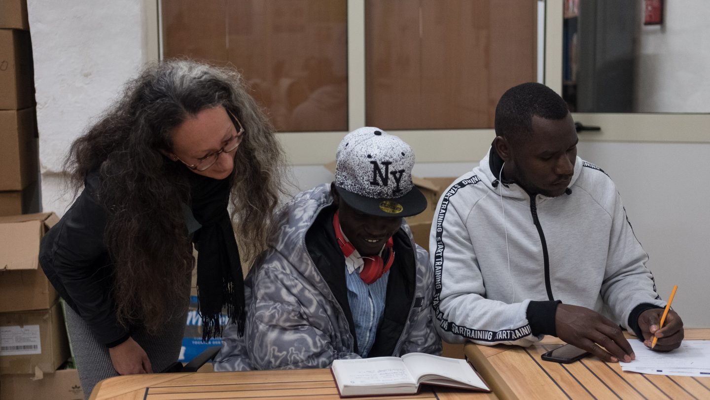 Volunteer teacher and students at Blue Door English. © UNHCR/Joanna Demarco