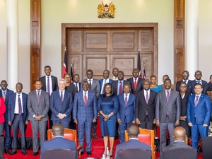 A group of people standing in two rows in front of an audience