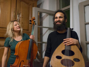 Belgium. An iraki refugee playing lute.