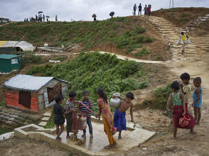 Bangladesh. Rohingya refugees fill containers at a water well in Kutupalong settlement
