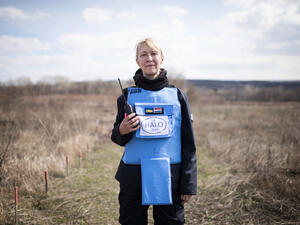 Ukraine. A female deminer in partially cleared minefield in the Donbas area