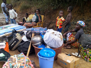 Asylum seekers fleeing political tension wait at the Buutuo border crossing in Liberia. 