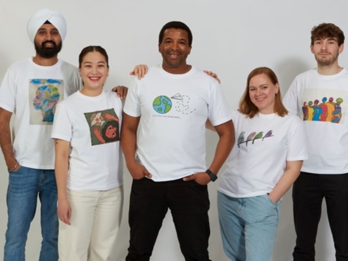 UNHCR colleagues wearing the shirts part of the Hope away from Home collection.
