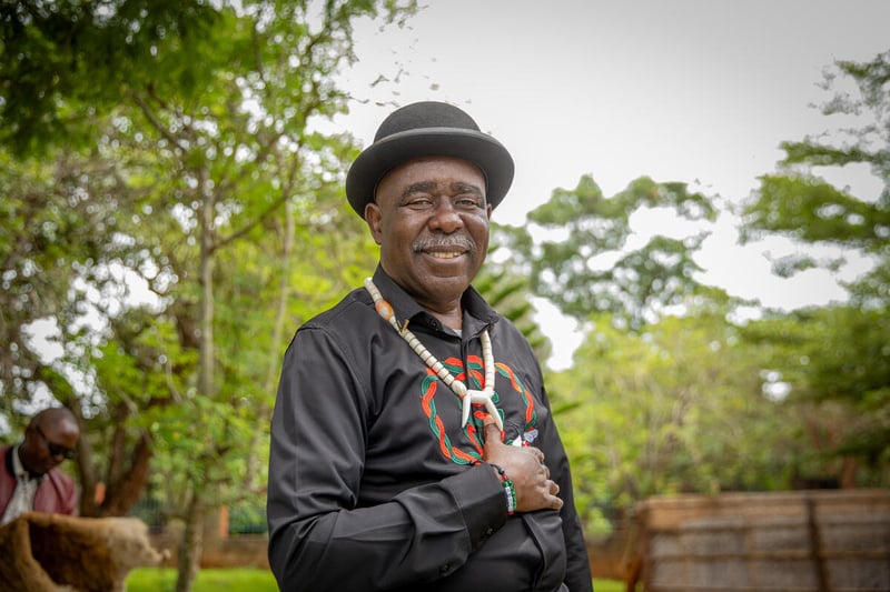 Daria, a Ukrainian refugee and biologist, uses a handheld machine to test soil in a crate.