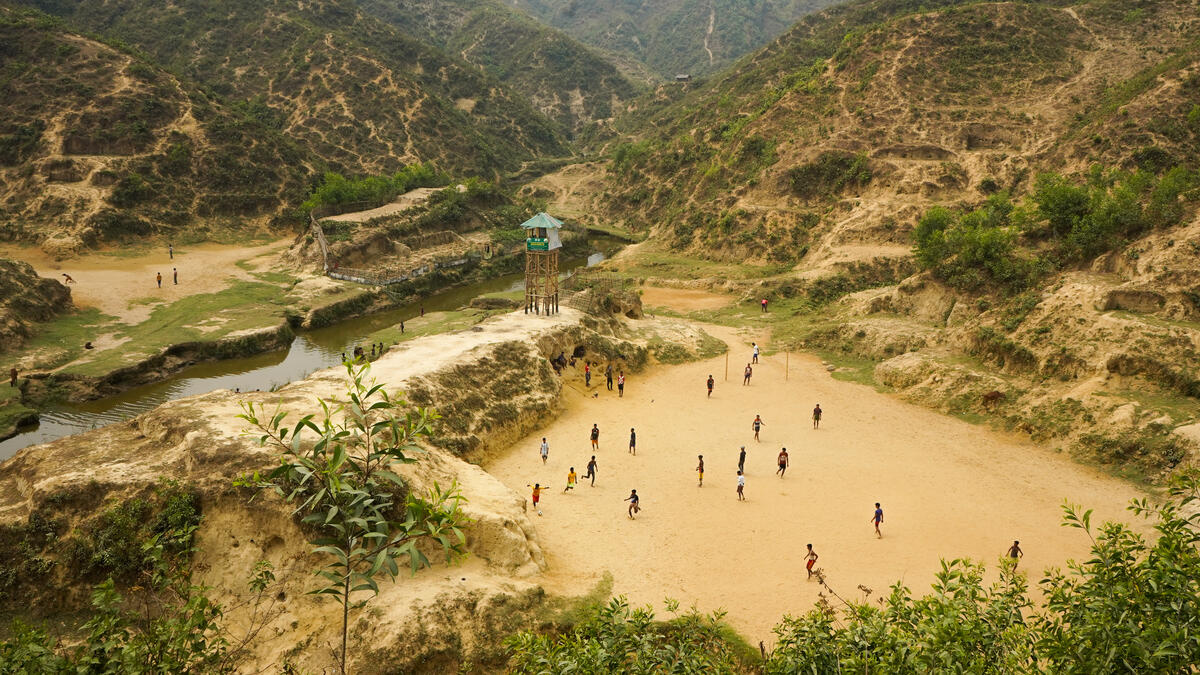 Boys playing soccer at open field in camps