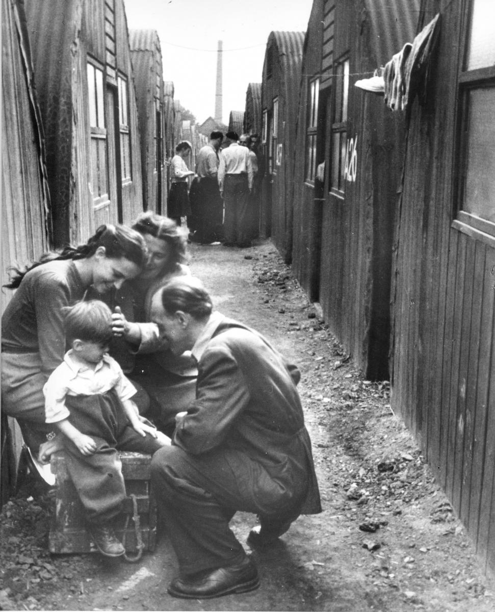 Black and white photo of refugee family in a camp in Europe