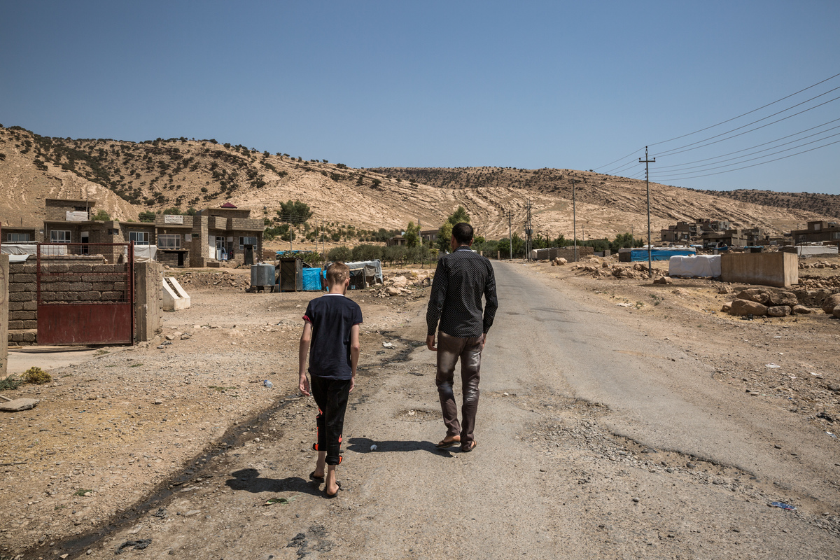 Iraq. Yazidi child gets ready to reunite with his mother in Canada