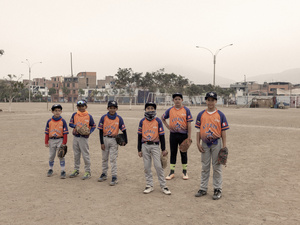 Six boys in baseball uniforms attend a traning session