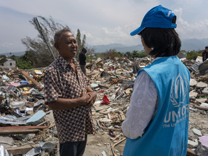 Indonesia. UNHCR staff with survivor of earthquake