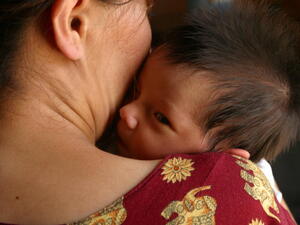 Turkmenistan. A woman holds her infant