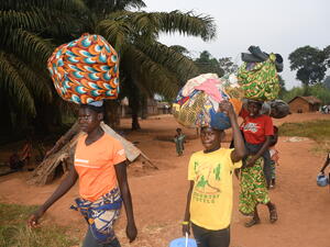 Families arrive in Ndu village in the Democratic Republic of the Congo after fleeing Bangassou town in the Central African Republic.