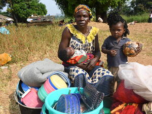 "We fled fearing that rebel groups would come and take over our town. We left everything behind and took a dugout canoe to cross the Ubangi river. We do not have food or a bed, but my daughter is constructing a shelter not far from here."

Yvette, 57, sits with two of her children in Ndu village in the Democratic Republic of the Congo (DRC) after fleeing Bangassou in the Central African Republic. It is the second time she has fled her country as a refugee – after escaping violence in 2017.