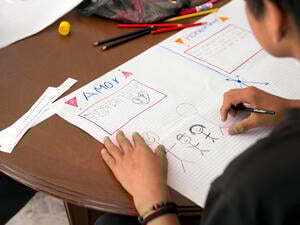 A child draws at a UNHCR-supported shelter in Mexico City for unaccompanied minors from northern Central America, November 2019.
