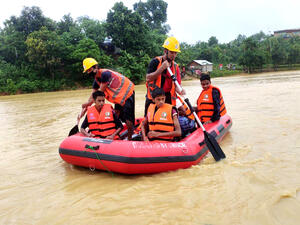 Rohingya refugees are paddled to safety at a site in Bangladesh's Cox's Bazar, after heavy monsoon rains  triggered flash floods and landslides.
