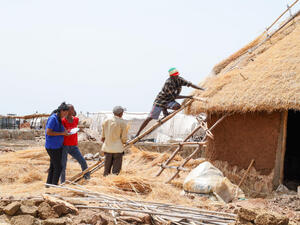 Sudan. Refugee civil engineers supervise shelter construction