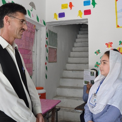 Abdur Rehman talking to a student in one of his schools in Attock.