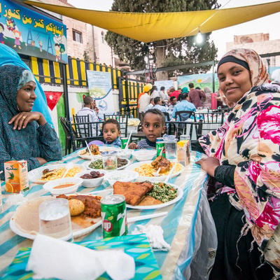 JORDAN. Refugees get together to break the Ramadan fast.