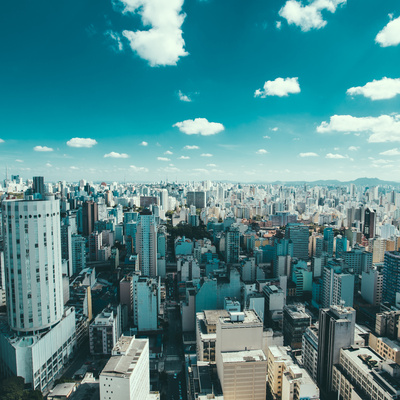Wide shot of buildings in Sao Paulo, Brazil, with blue sky and clouds overhead