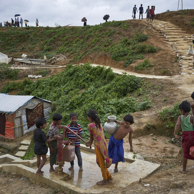 Bangladesh. Rohingya refugees fill containers at a water well in Kutupalong settlement