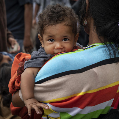 Colombia. A mother with her child crosses the Simon Bolivar Bridge, one of 7 legal entry points on the Colombia-Venezuela border