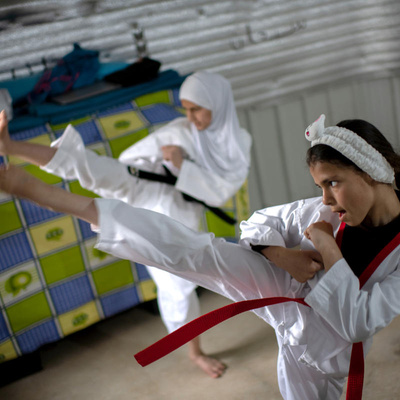 Syrian sisters practice Taekwondo at their home in Azraq refugee camp, Jordan, during lockdown.