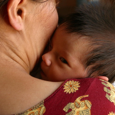 Turkmenistan. A woman holds her infant